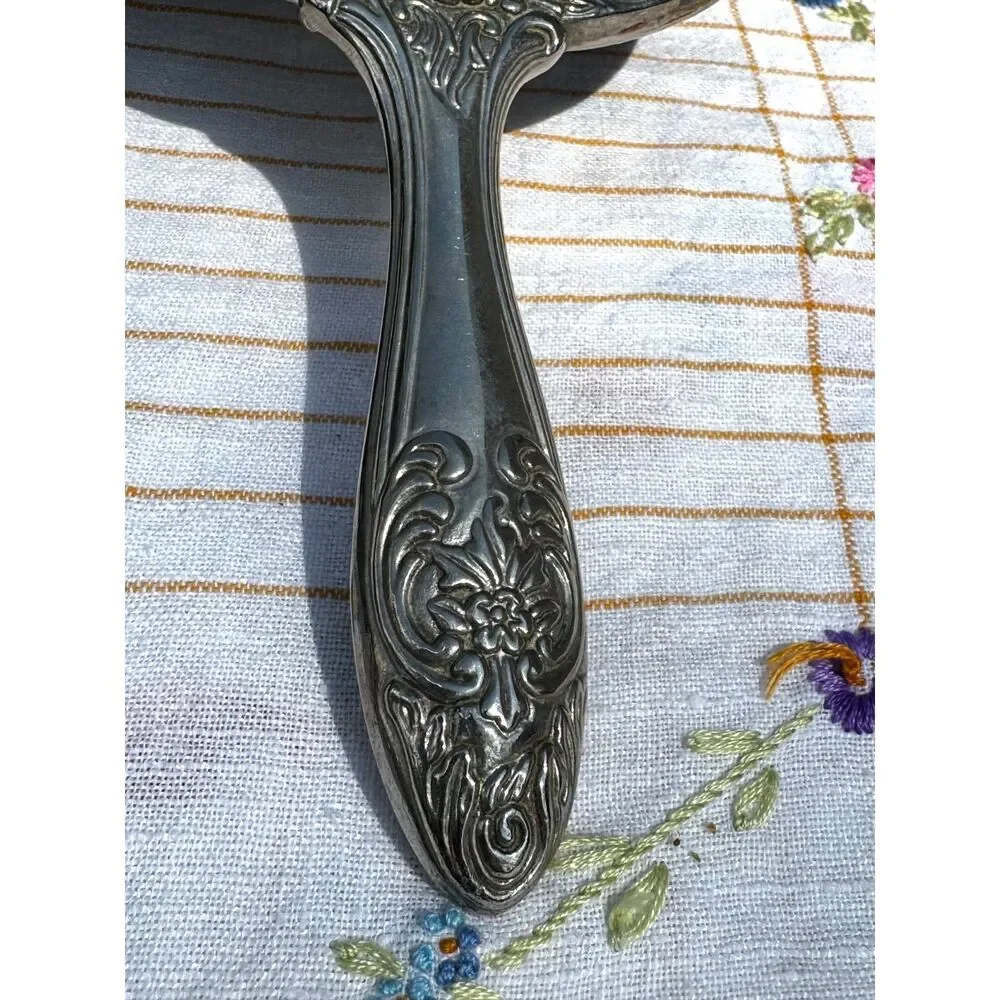 Vintage silver tone hand mirror embossed design on back so pretty
